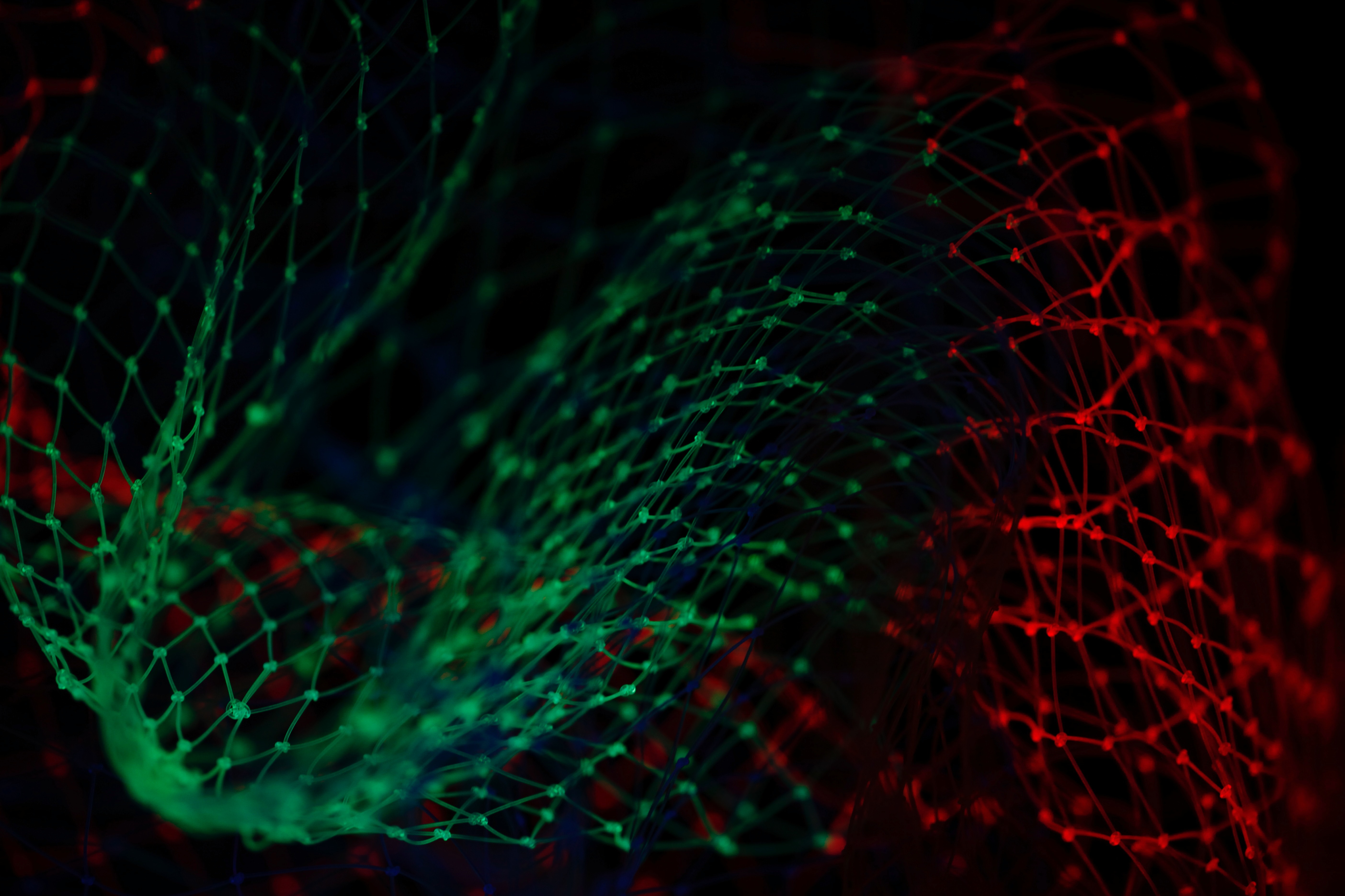 networks represented by green and red lines and dots on a black background