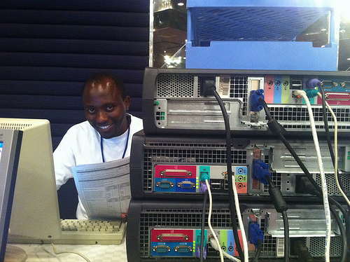 Man behind a computer, smiling.