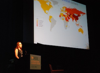 Speaker, in front of map with mainland Asia, highlighted in red.