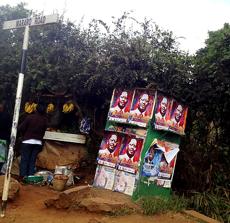 Political posters pasted on public wall, Kenya