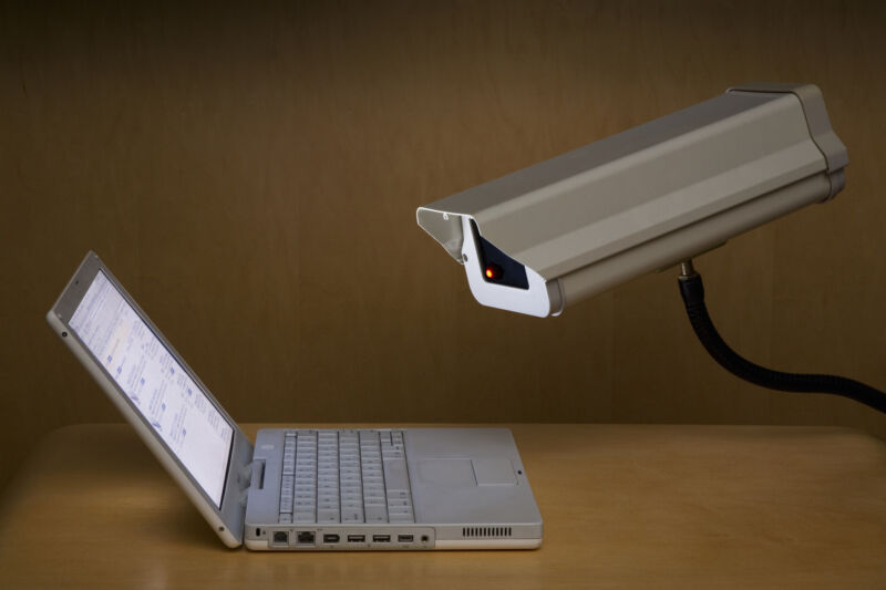 Image of a security camera monitoring a laptop screen from Getty Images